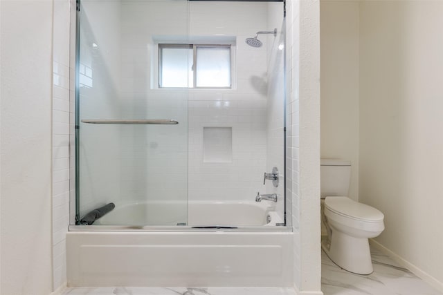 bathroom featuring toilet, shower / bath combination with glass door, and baseboards