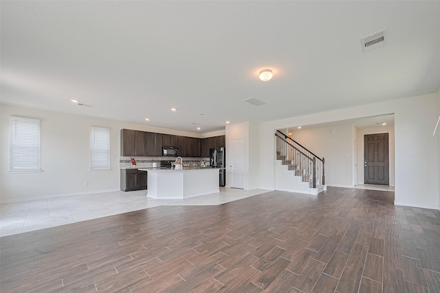 25327 Cheshire Knoll St, Katy, TX 77493 - unfurnished living room with stairway, light wood-style flooring, baseboards, and recessed lighting