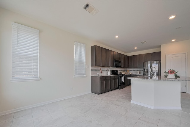 25327 Cheshire Knoll St, Katy, TX 77493 - kitchen with black appliances, a sink, dark brown cabinetry, decorative backsplash, and recessed lighting