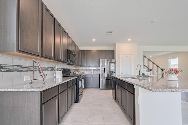 25327 Cheshire Knoll St, Katy, TX 77493 - kitchen with black appliances, a sink, backsplash, light stone countertops, and dark brown cabinets