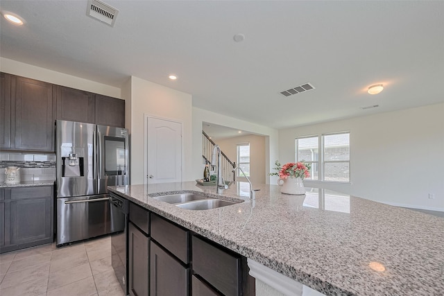 25327 Cheshire Knoll St, Katy, TX 77493 - kitchen featuring stainless steel refrigerator with ice dispenser, black dishwasher, a sink, light stone countertops, and dark brown cabinetry