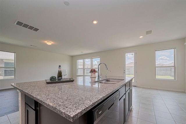 25327 Cheshire Knoll St, Katy, TX 77493 - kitchen with dishwasher, a sink, an island with sink, light tile patterned flooring, and light stone counters