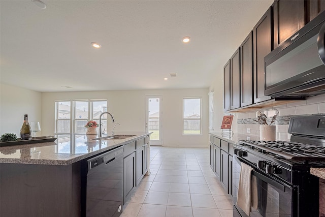 25327 Cheshire Knoll St, Katy, TX 77493 - kitchen with black appliances, a sink, plenty of natural light, light stone counters, and recessed lighting