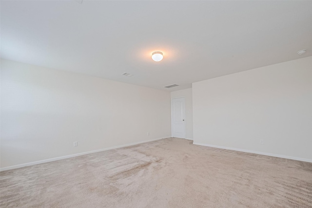 25327 Cheshire Knoll St, Katy, TX 77493 - empty room featuring light carpet, baseboards, and a smoke detector