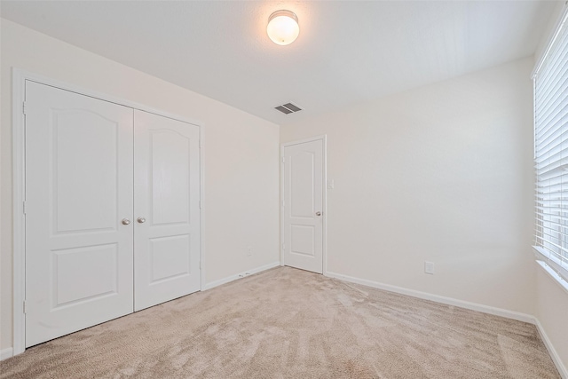 25327 Cheshire Knoll St, Katy, TX 77493 - unfurnished bedroom with light colored carpet, a closet, baseboards, and multiple windows