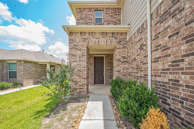25327 Cheshire Knoll St, Katy, TX 77493 - view of exterior entry with brick siding and a yard