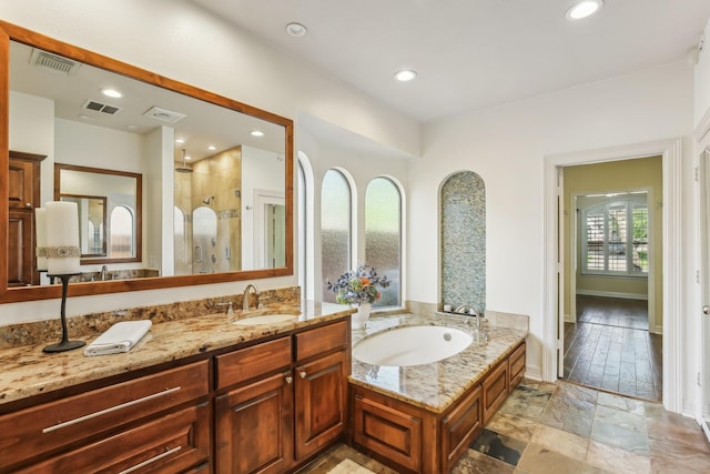 15614 Stone Gables Ln, Houston, TX 77044 - full bath with a stall shower, a bath, vanity, recessed lighting, and baseboards