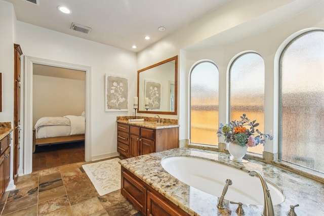 15614 Stone Gables Ln, Houston, TX 77044 - bathroom featuring vanity, healthy amount of natural light, ensuite bathroom, and recessed lighting