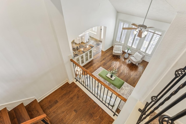 15614 Stone Gables Ln, Houston, TX 77044 - stairway featuring hardwood / wood-style flooring, arched walkways, ceiling fan, and baseboards