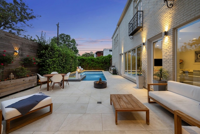 2114 Wroxton Rd, Houston, TX 77005 - pool at dusk featuring a fenced backyard, a patio area, a fenced in pool, and an outdoor hangout area