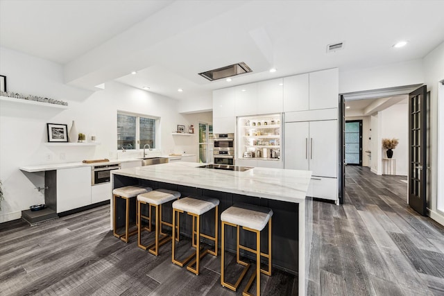 2114 Wroxton Rd, Houston, TX 77005 - kitchen featuring a center island, paneled fridge, modern cabinets, and white cabinets