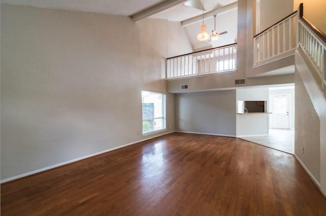 16007 Sierra Vista Dr, Houston, TX 77083 - unfurnished living room with visible vents, wood finished floors, baseboards, beam ceiling, and a notable chandelier