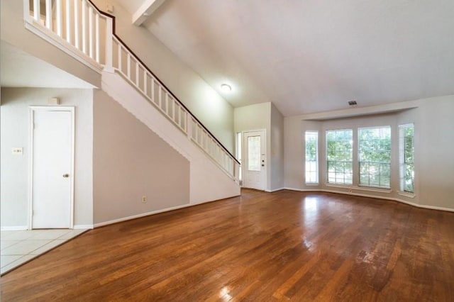 16007 Sierra Vista Dr, Houston, TX 77083 - unfurnished living room with wood finished floors, high vaulted ceiling, and baseboards