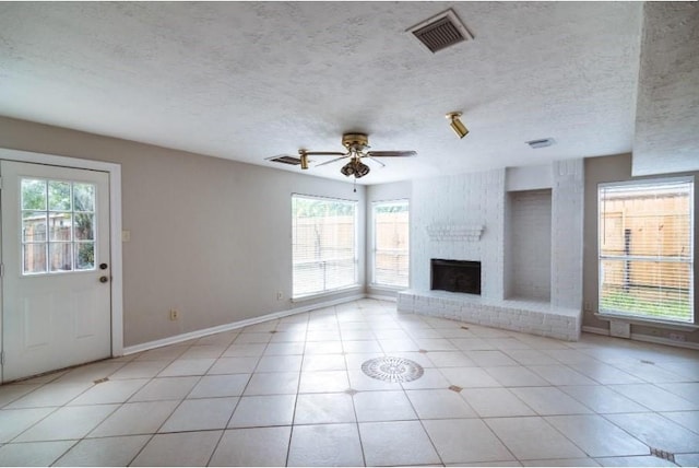 16007 Sierra Vista Dr, Houston, TX 77083 - unfurnished living room with baseboards, a fireplace, a textured ceiling, visible vents, and ceiling fan