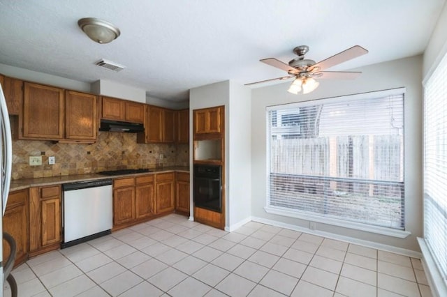16007 Sierra Vista Dr, Houston, TX 77083 - kitchen with brown cabinetry, under cabinet range hood, visible vents, and black appliances
