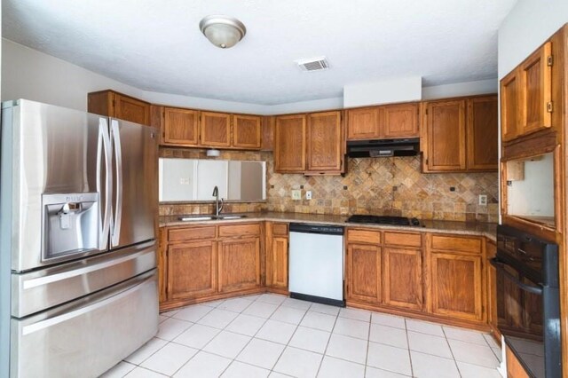 16007 Sierra Vista Dr, Houston, TX 77083 - kitchen with stainless steel refrigerator with ice dispenser, white dishwasher, a sink, under cabinet range hood, and brown cabinets