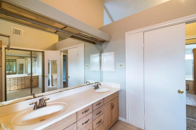 16007 Sierra Vista Dr, Houston, TX 77083 - bathroom with a sink, visible vents, double vanity, and tile patterned flooring
