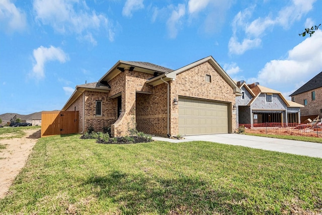 view of front facade featuring an attached garage, brick siding, a front yard, and concrete driveway