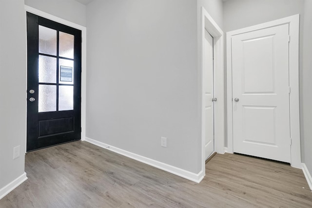 entryway featuring wood finished floors and baseboards