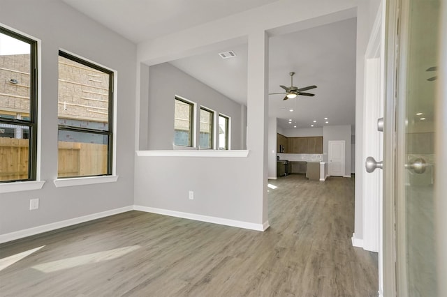 unfurnished room featuring ceiling fan, baseboards, wood finished floors, and visible vents