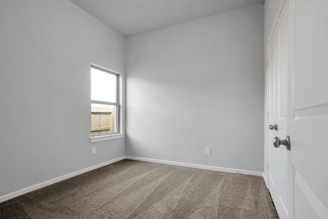 unfurnished room featuring carpet floors and baseboards