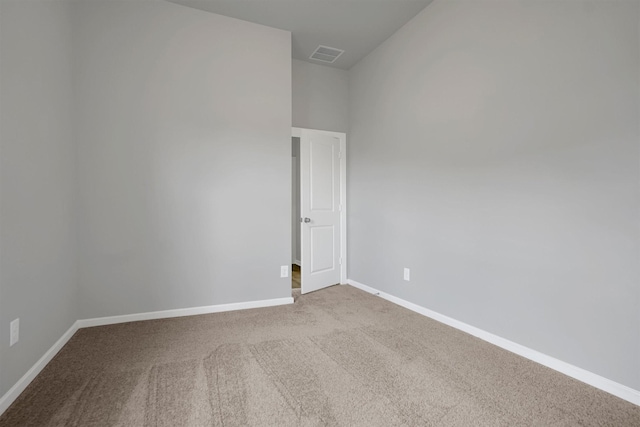 carpeted spare room with baseboards and visible vents