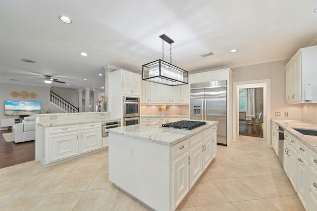 15431 Greens Cove Way, Houston, TX 77059 - kitchen with stainless steel appliances, a peninsula, a kitchen island, recessed lighting, and tasteful backsplash