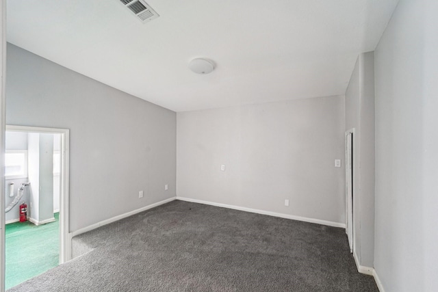 5910 Edward Dr, Houston, TX 77396 - empty room featuring dark colored carpet, visible vents, and baseboards