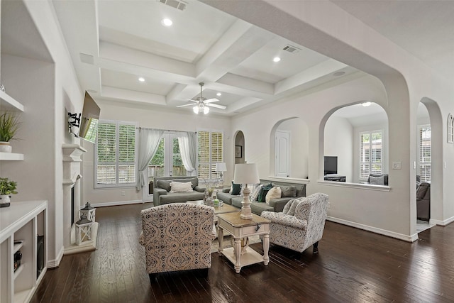 living area featuring a healthy amount of sunlight, dark wood-style flooring, ceiling fan, and visible vents