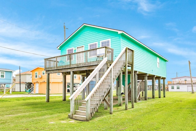 back of house featuring a yard, a deck, and stairs