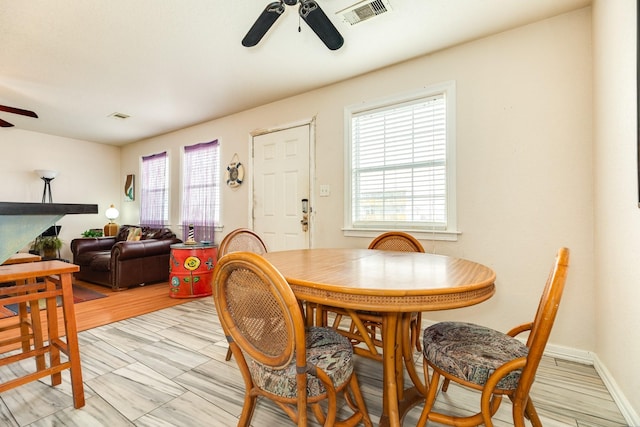 dining space featuring visible vents and ceiling fan