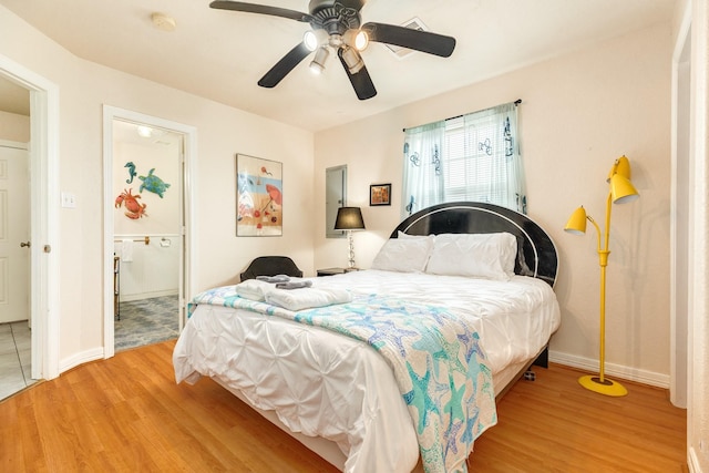 bedroom featuring light wood-style flooring, baseboards, and a ceiling fan