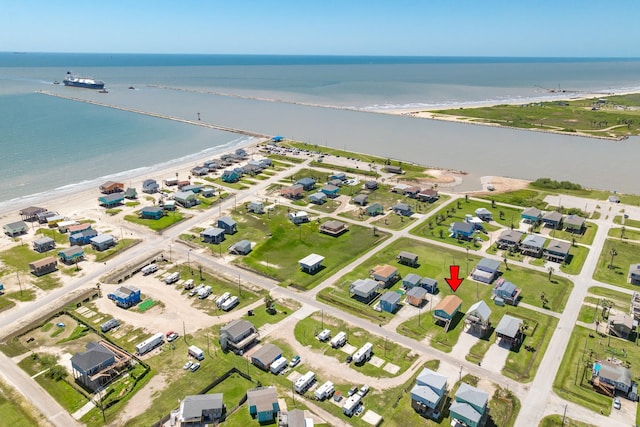 birds eye view of property with a water view and a view of the beach