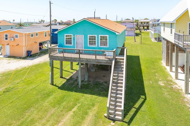 back of property with a deck, a carport, a lawn, dirt driveway, and stairway