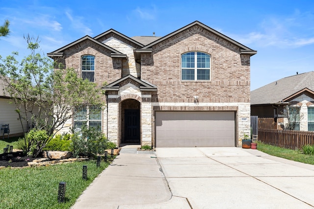 12420 Southern Trail Ct, Magnolia, TX 77354 - view of front of home featuring concrete driveway, stone siding, an attached garage, brick siding, and fence