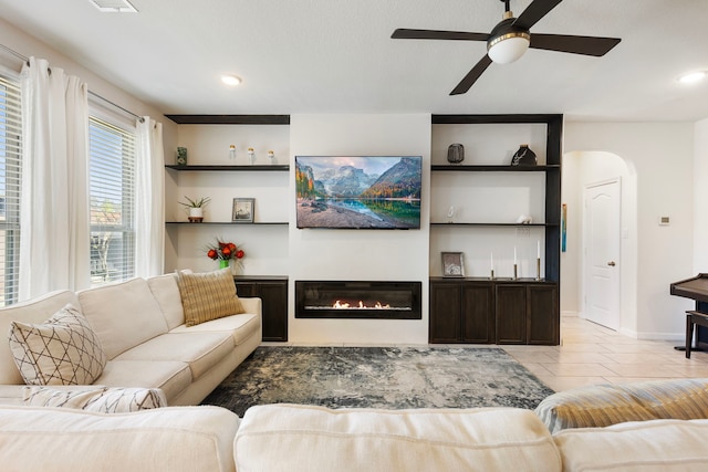 12420 Southern Trail Ct, Magnolia, TX 77354 - living area featuring light tile patterned floors, a ceiling fan, a glass covered fireplace, and recessed lighting