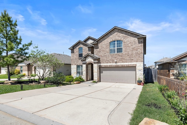 12420 Southern Trail Ct, Magnolia, TX 77354 - view of front of home with brick siding, fence, a garage, and concrete driveway