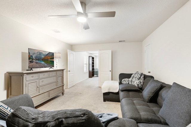 12420 Southern Trail Ct, Magnolia, TX 77354 - living area with visible vents, ceiling fan, light carpet, and a textured ceiling