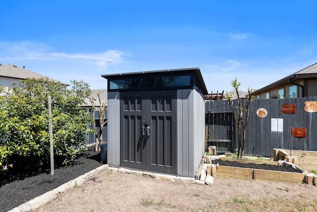 12420 Southern Trail Ct, Magnolia, TX 77354 - view of shed with a vegetable garden and fence private yard