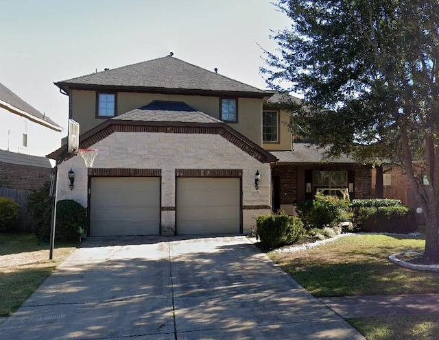 view of front facade with an attached garage, driveway, and brick siding