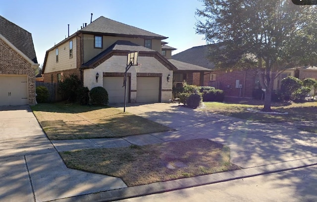 view of front of property with concrete driveway, brick siding, fence, and a garage