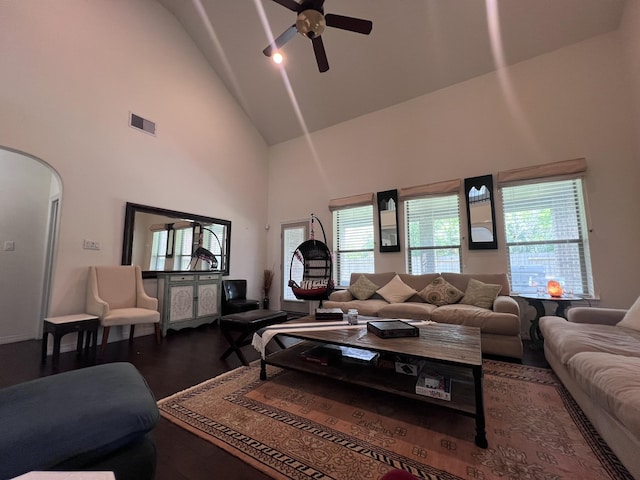 living area with visible vents, wood finished floors, ceiling fan, high vaulted ceiling, and arched walkways