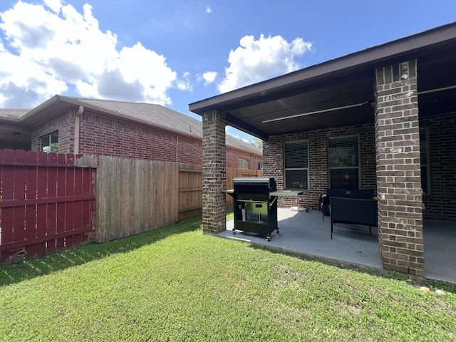 view of yard featuring fence and a patio