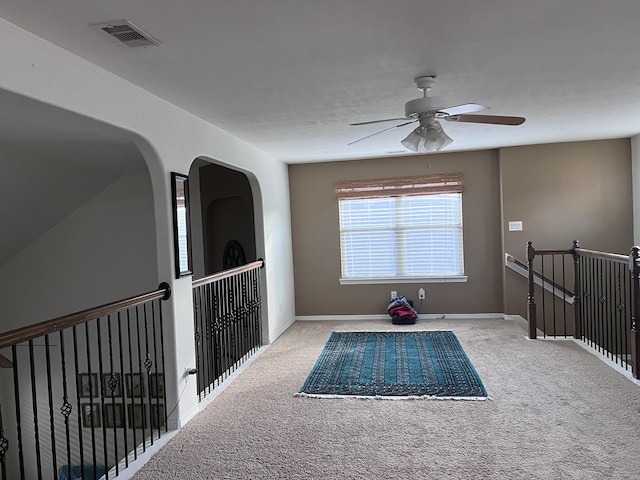corridor with baseboards, an upstairs landing, carpet flooring, and visible vents