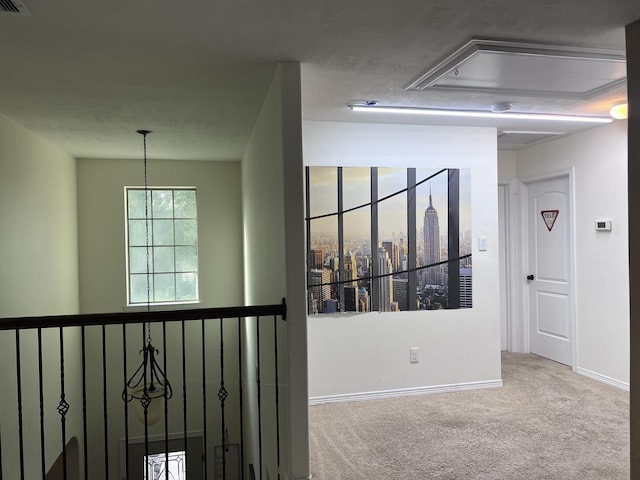 hallway with baseboards and carpet