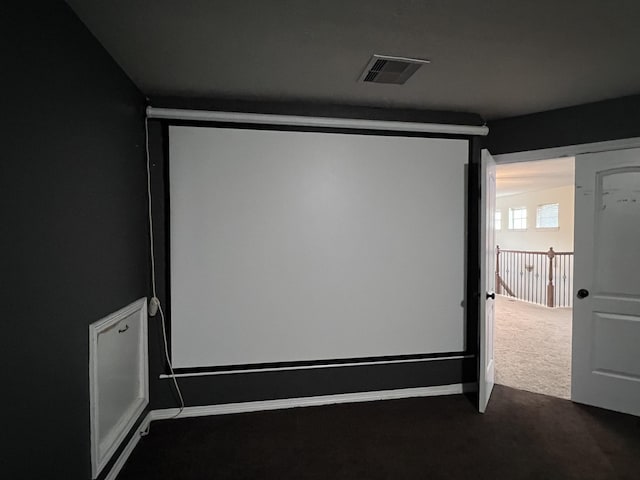 cinema room featuring dark carpet and visible vents