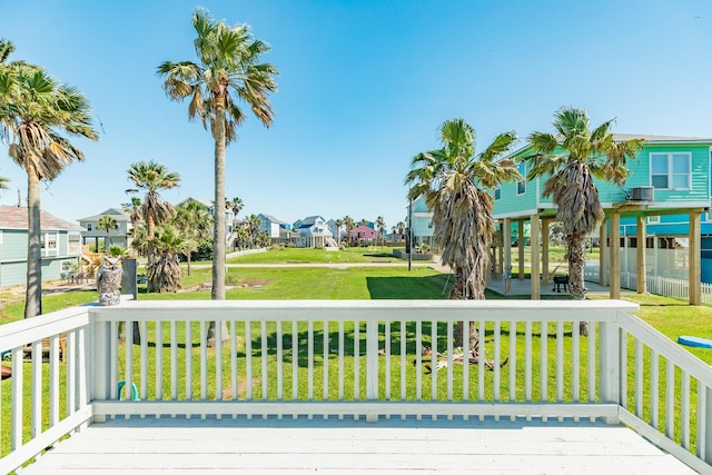 11213 Schwartz Dr, Galveston, TX 77554 - wooden deck featuring a yard, covered porch, and a residential view