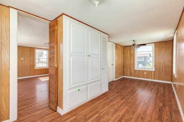11213 Schwartz Dr, Galveston, TX 77554 - unfurnished bedroom featuring wooden walls, baseboards, and wood finished floors