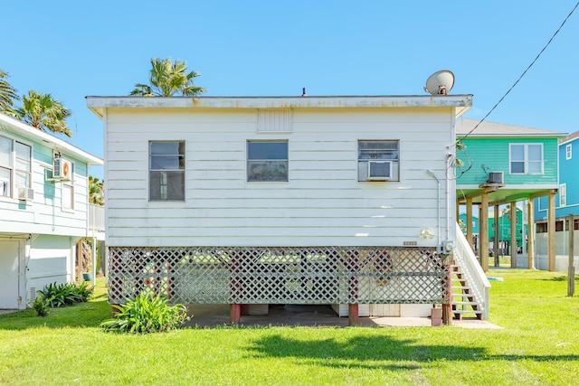 11213 Schwartz Dr, Galveston, TX 77554 - rear view of house featuring central AC unit, stairway, and a lawn