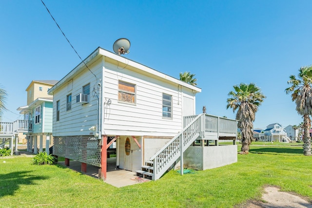 11213 Schwartz Dr, Galveston, TX 77554 - rear view of property with cooling unit, a yard, a wooden deck, and stairway